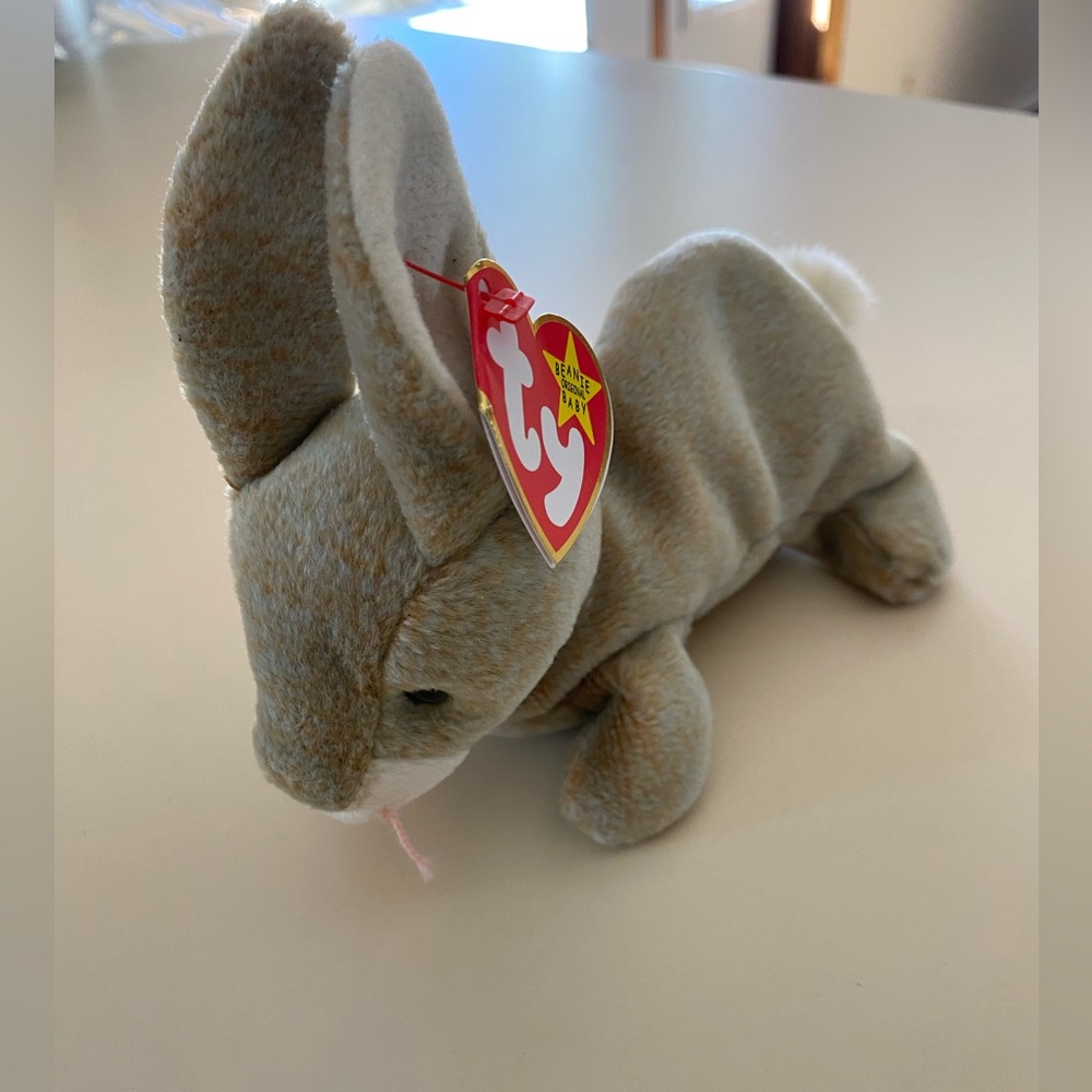 NWT BEANIE BABY - “Nibbly” bunny, kept in collectible case.